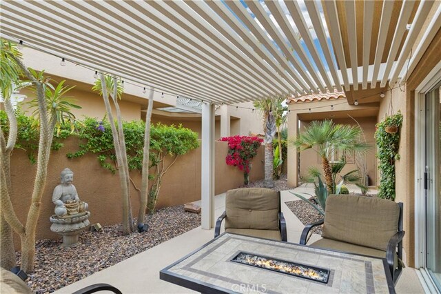 view of patio featuring a pergola and a fire pit