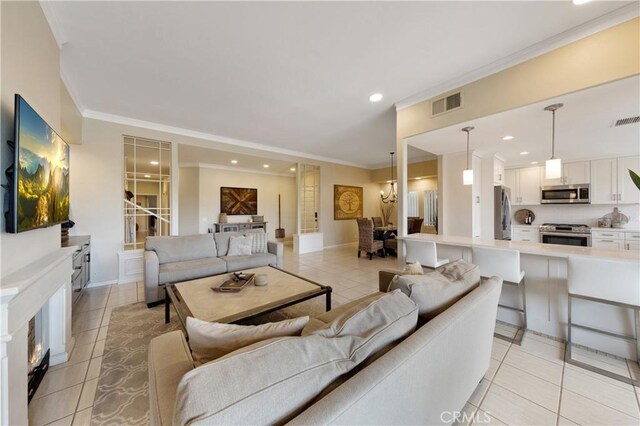 living room featuring ornamental molding and light tile patterned floors