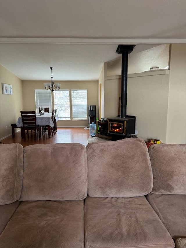 living room with a chandelier and a wood stove