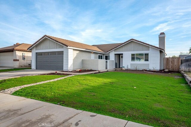 single story home featuring a front lawn and a garage