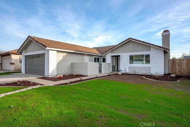 ranch-style home with a garage and a front yard