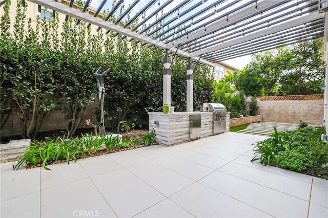 view of patio / terrace with exterior kitchen, a grill, and a pergola