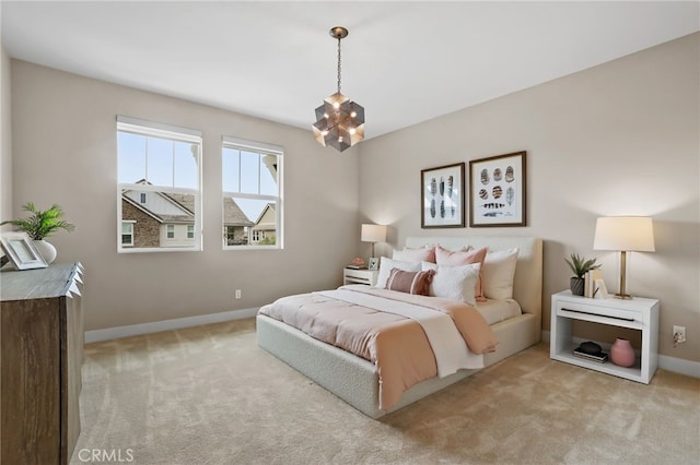 bedroom featuring light carpet and a chandelier