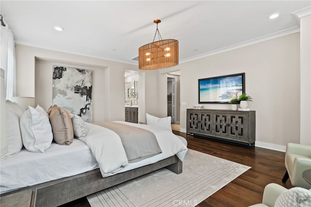 bedroom with ensuite bath, dark hardwood / wood-style flooring, and crown molding