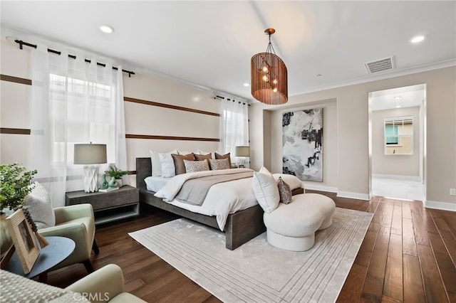 bedroom featuring dark hardwood / wood-style flooring and crown molding