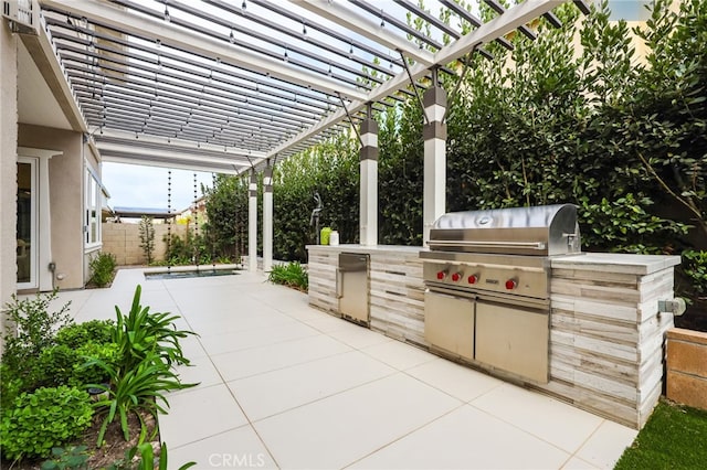 view of patio / terrace featuring a pergola, a grill, and exterior kitchen