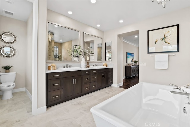 bathroom with toilet, vanity, ornamental molding, and a bath