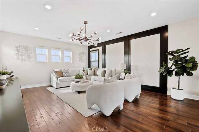 living room with a chandelier and dark hardwood / wood-style floors