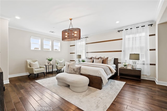 bedroom with dark hardwood / wood-style flooring, crown molding, and a chandelier