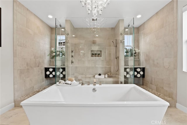 bathroom with a chandelier, tile walls, and separate shower and tub