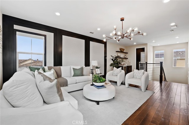 living room featuring wood-type flooring and a notable chandelier