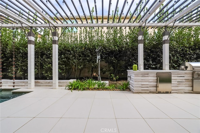 view of patio featuring a pergola, a grill, and exterior kitchen