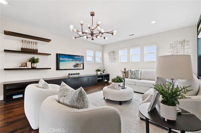 living room with dark wood-type flooring and a chandelier