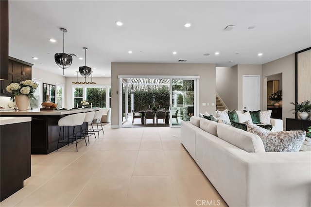 tiled living room featuring a healthy amount of sunlight