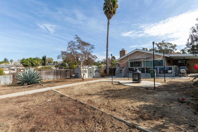 view of yard with a storage unit and a patio