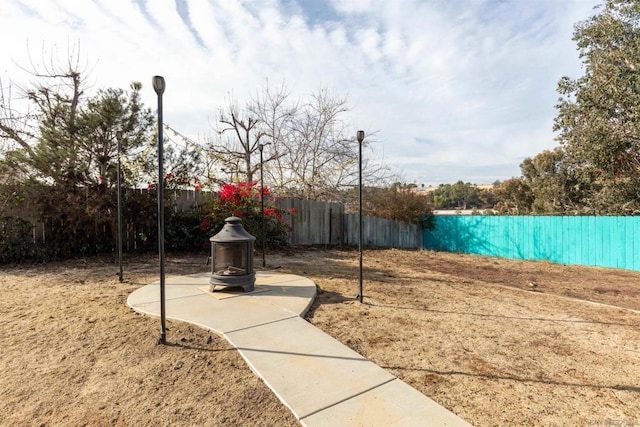 view of yard with an outdoor fire pit