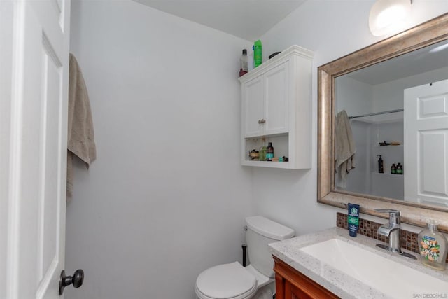 bathroom featuring toilet and vanity