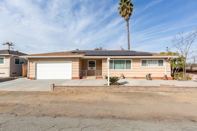 ranch-style house featuring solar panels and a garage