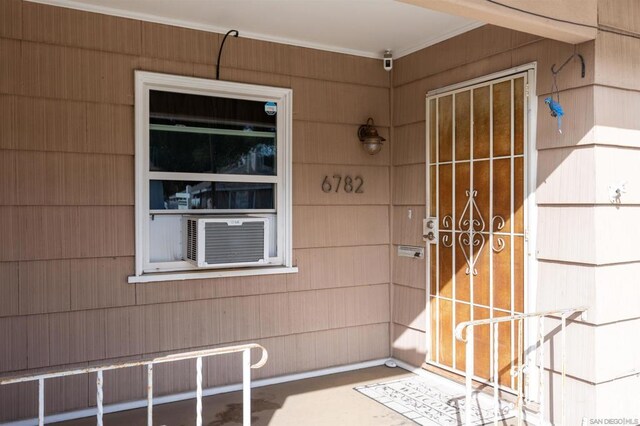 doorway to property featuring cooling unit