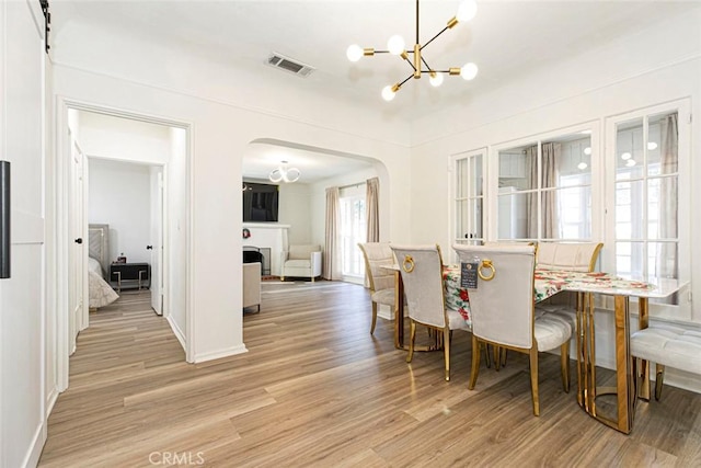 dining space featuring a chandelier and light hardwood / wood-style flooring