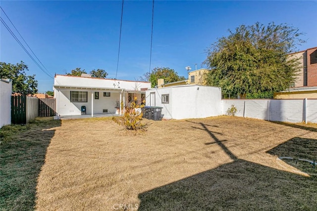 rear view of house with a lawn