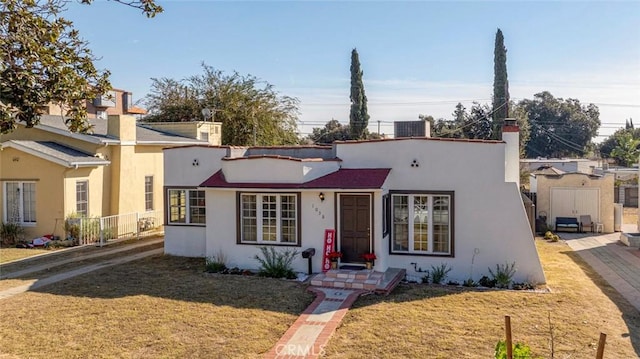 view of front facade featuring a front lawn and central AC unit