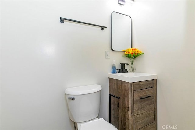 bathroom featuring toilet and vanity