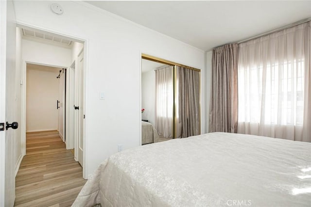 bedroom featuring a closet and light hardwood / wood-style flooring