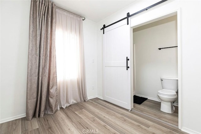 bathroom featuring toilet and hardwood / wood-style flooring