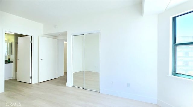 unfurnished bedroom featuring light wood-type flooring