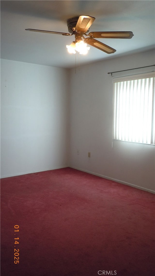 carpeted empty room featuring ceiling fan