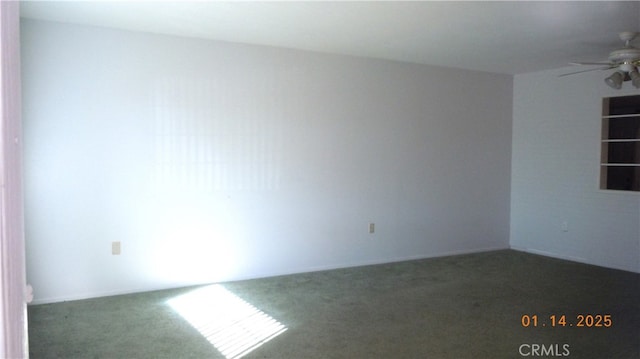 unfurnished room with ceiling fan and dark carpet