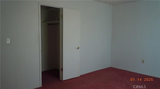 unfurnished bedroom with carpet floors, a spacious closet, and a closet