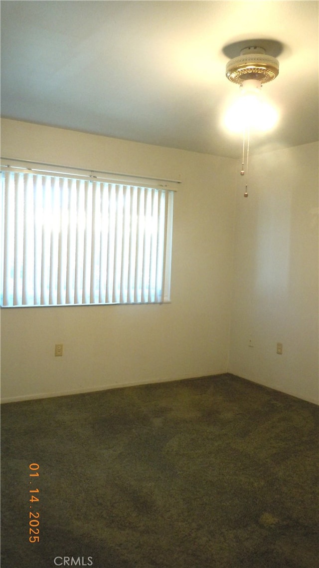 empty room featuring dark carpet