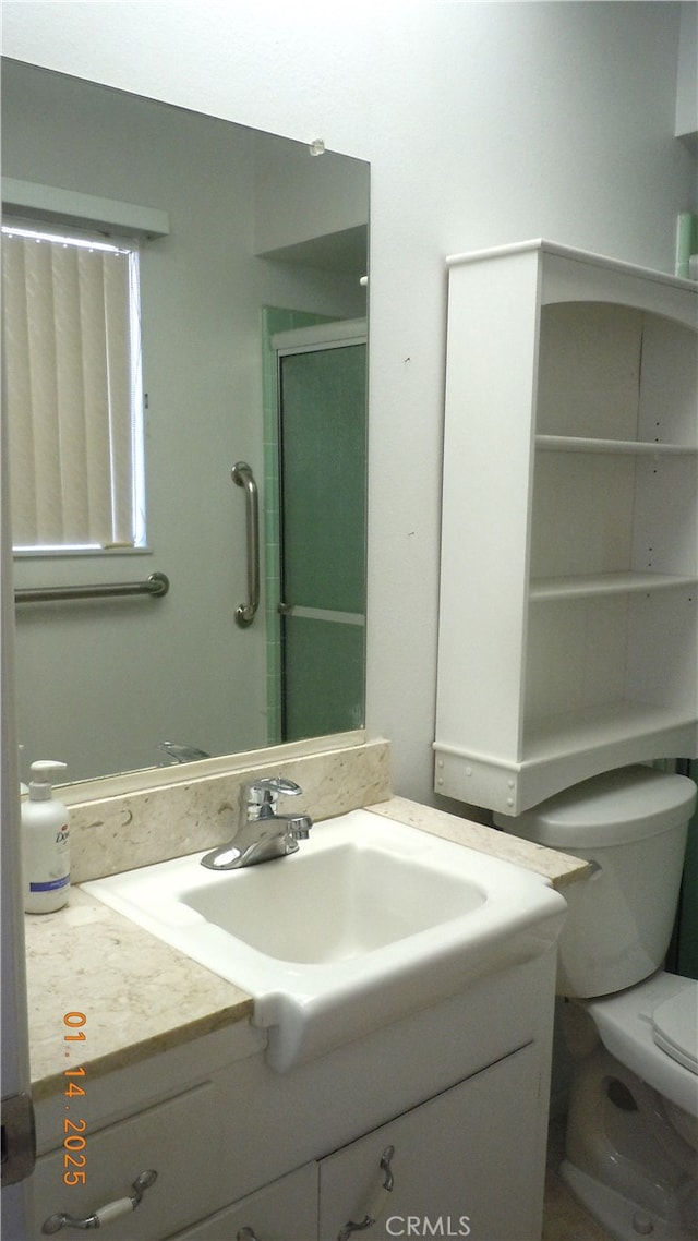 bathroom with vanity, toilet, and walk in shower