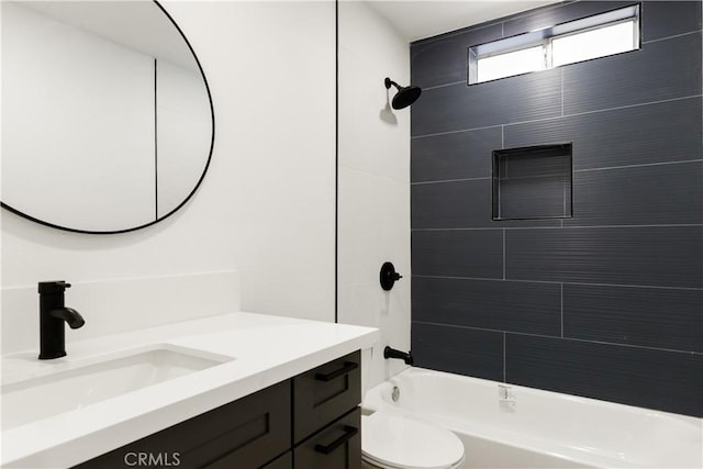 full bathroom featuring toilet, tiled shower / bath combo, and vanity