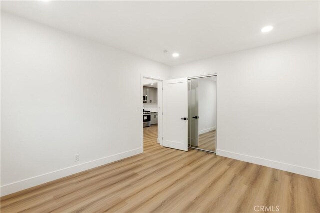 empty room with light hardwood / wood-style flooring