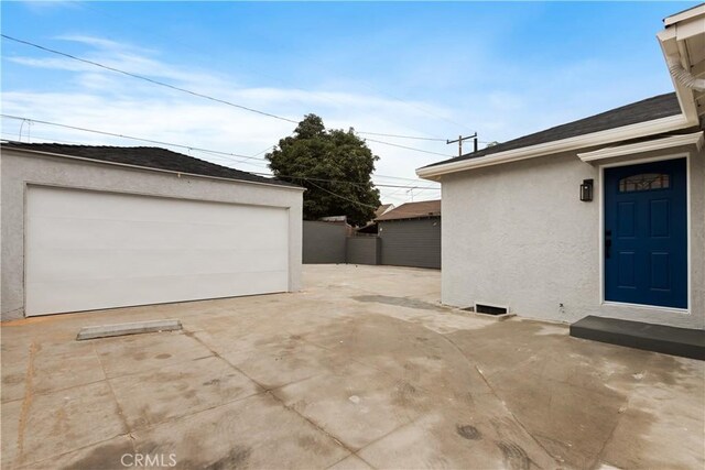 exterior space with a garage and an outdoor structure