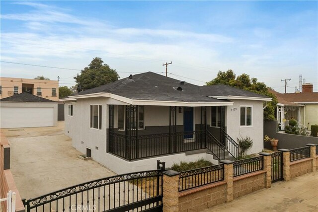 view of front of house featuring a garage and an outdoor structure