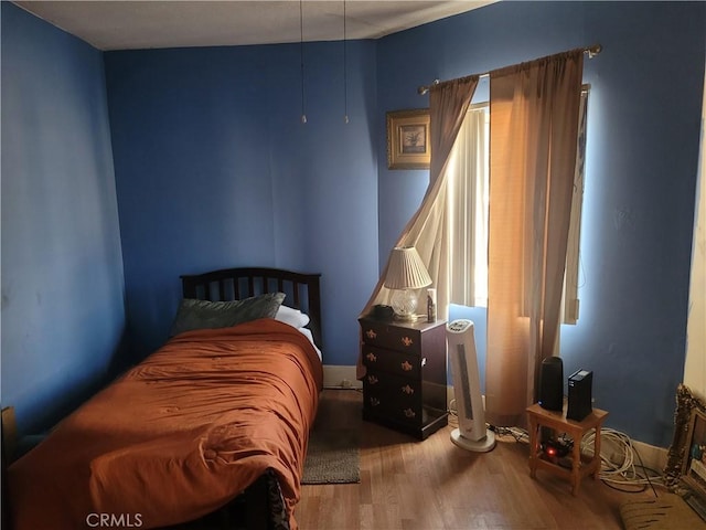 bedroom with wood-type flooring