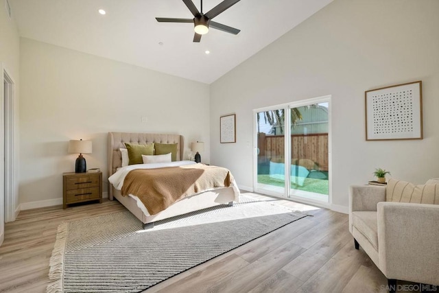 bedroom with ceiling fan, access to exterior, light hardwood / wood-style floors, and high vaulted ceiling