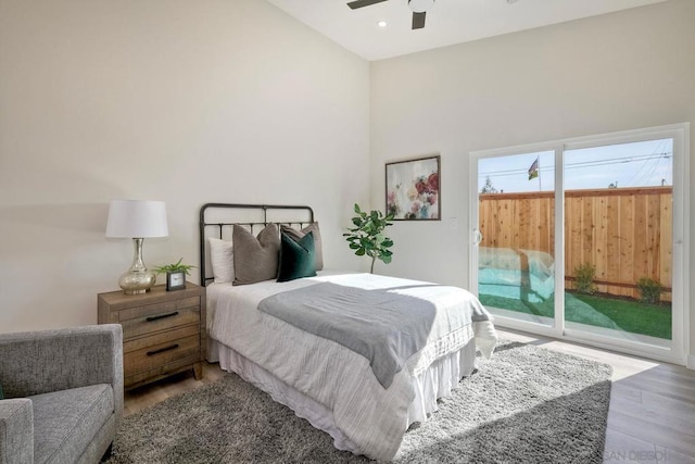 bedroom featuring ceiling fan, access to exterior, and light hardwood / wood-style floors