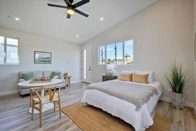 bedroom featuring ceiling fan, lofted ceiling, and light wood-type flooring