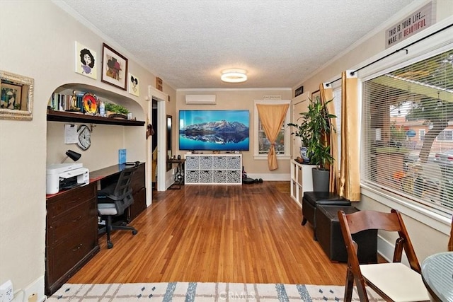 home office with hardwood / wood-style floors and a textured ceiling