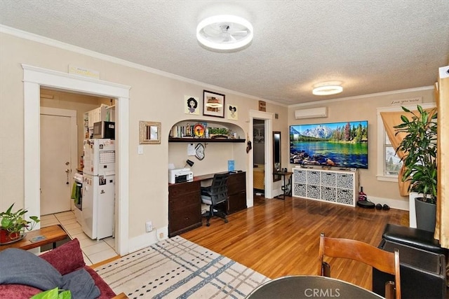 living room with crown molding, light hardwood / wood-style flooring, and a textured ceiling