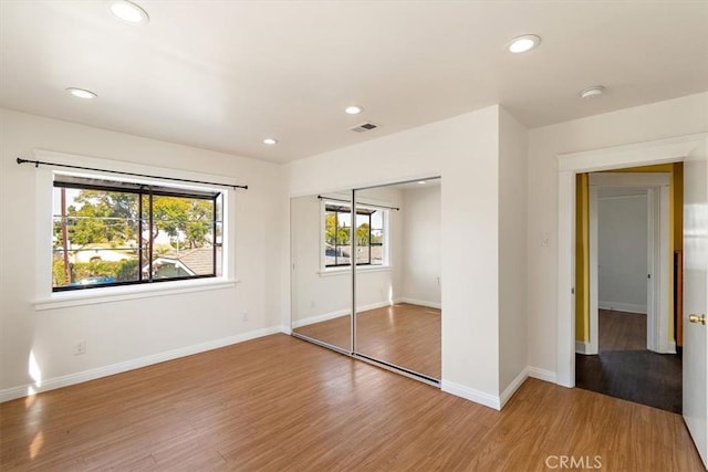 unfurnished bedroom featuring hardwood / wood-style flooring and a closet