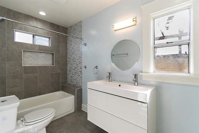 full bathroom with vanity, toilet, and tiled shower / bath combo