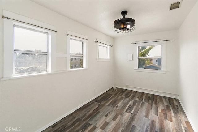 empty room featuring dark hardwood / wood-style flooring