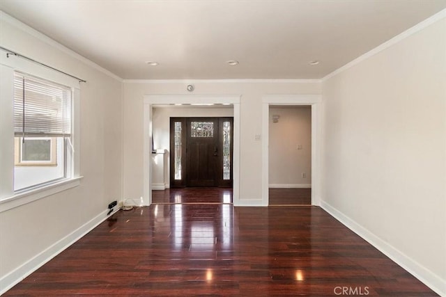 foyer entrance with dark hardwood / wood-style flooring and ornamental molding