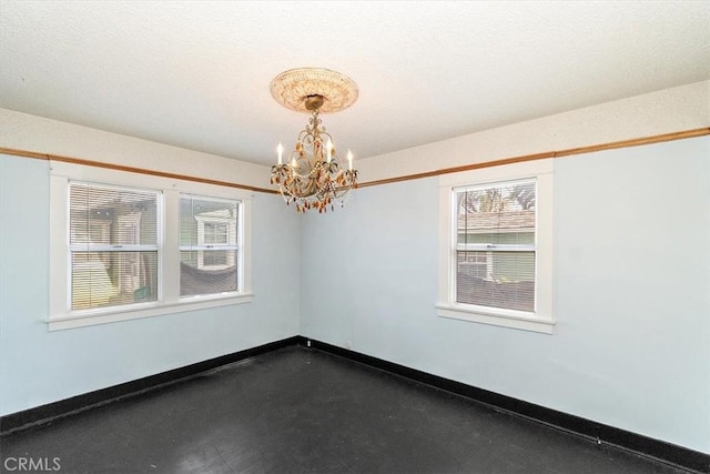 empty room with a chandelier and a healthy amount of sunlight